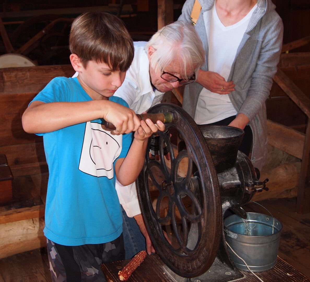 A young boy is using a grinding wheel.