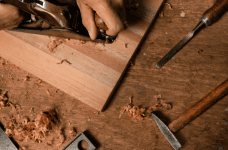 Carpenter's tools on a wooden cutting board.