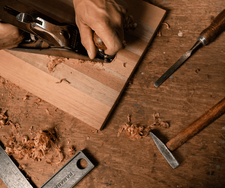 Carpenter's tools on a wooden cutting board.